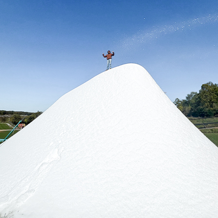 A person standing on a huge snowdrift