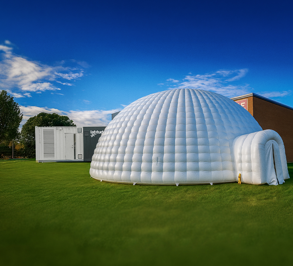 Inflatable igloo in front of a Latitude 90 L30 snow machine