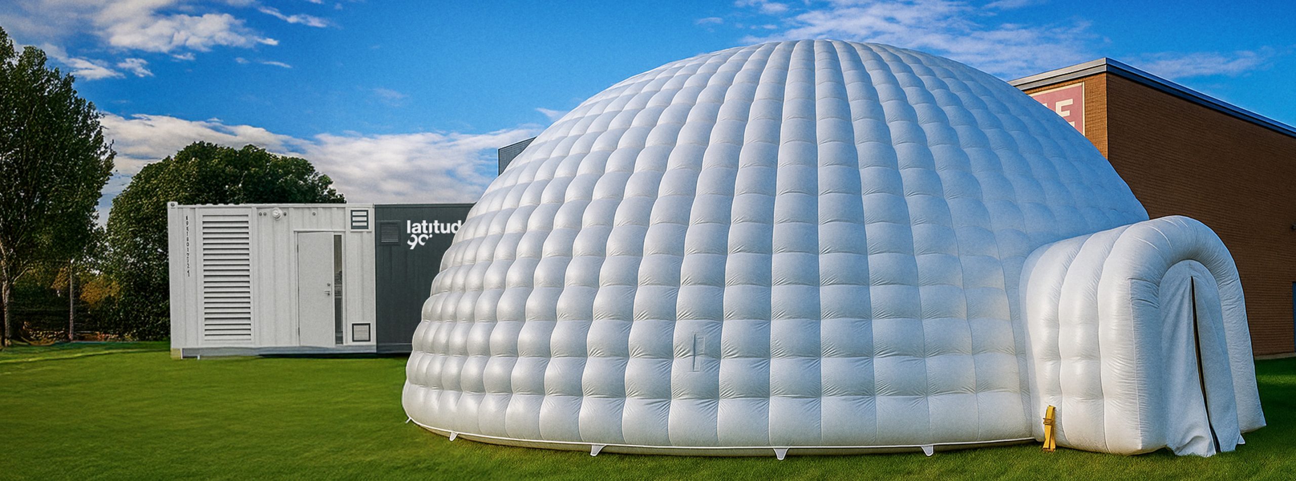 Inflatable igloo in front of a Latitude 90 L30 snow machine