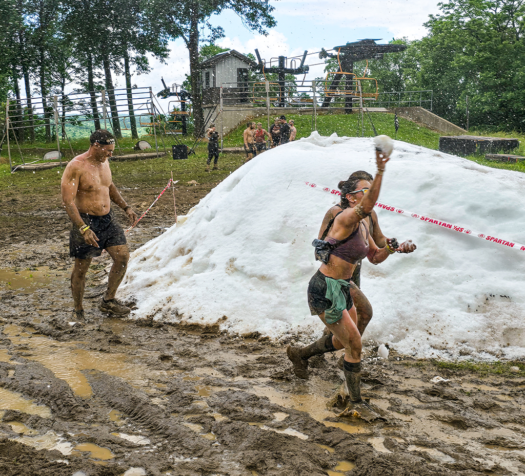 A man and two women near a snowbank during a Spartan Race obstacle course